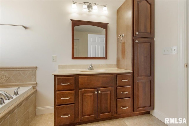 full bathroom featuring tiled bath, vanity, and tile patterned floors