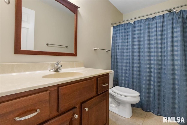 bathroom featuring toilet, a shower with curtain, vanity, and tile patterned floors