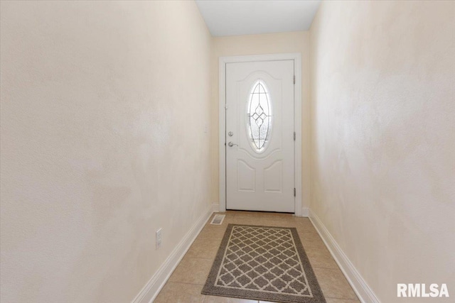 entryway featuring light tile patterned floors and baseboards