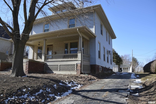 traditional style home with covered porch and driveway