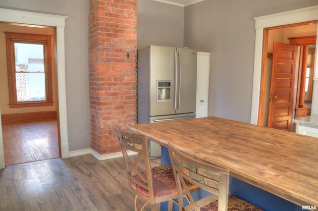 644 S Randolph St, Macomb, IL 61455 - kitchen with light countertops, dark wood-type flooring, ornamental molding, stainless steel fridge, and baseboards