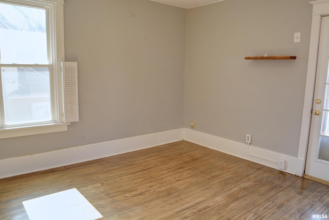 644 S Randolph St, Macomb, IL 61455 - empty room with a wealth of natural light, baseboards, and light wood finished floors