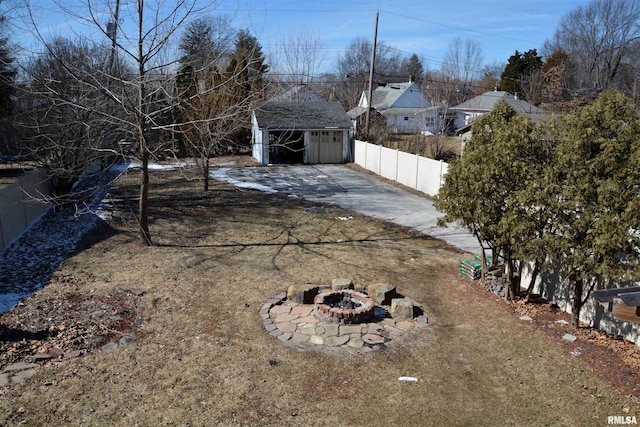 644 S Randolph St, Macomb, IL 61455 - view of yard with an outbuilding, fence, and a fire pit