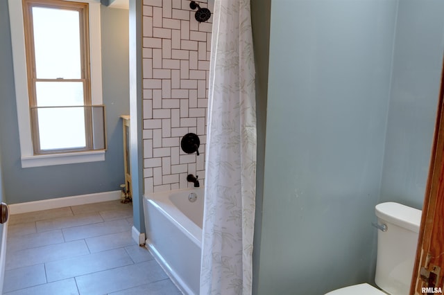 644 S Randolph St, Macomb, IL 61455 - bathroom with baseboards, shower / bathtub combination with curtain, toilet, and tile patterned floors