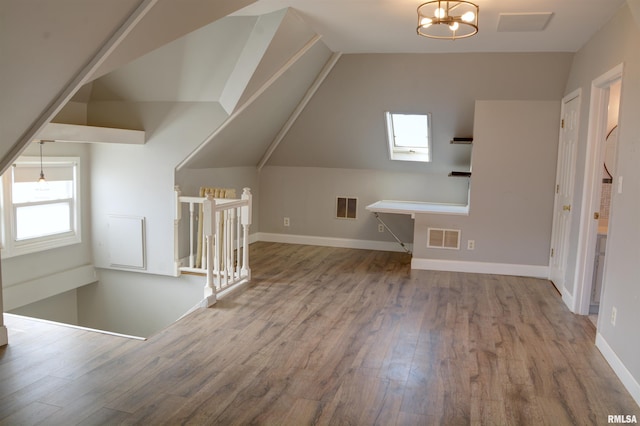 644 S Randolph St, Macomb, IL 61455 - bonus room with baseboards, visible vents, vaulted ceiling, and wood finished floors