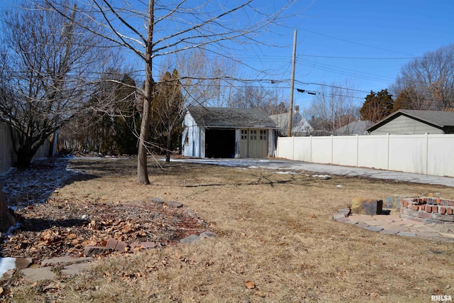 644 S Randolph St, Macomb, IL 61455 - view of yard with an outbuilding, a fire pit, and fence