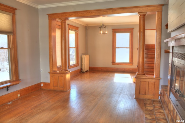 644 S Randolph St, Macomb, IL 61455 - interior space with baseboards, radiator heating unit, wood finished floors, crown molding, and ornate columns