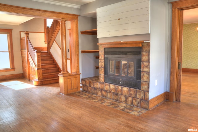 644 S Randolph St, Macomb, IL 61455 - unfurnished living room with stairs, baseboards, wood finished floors, and a glass covered fireplace