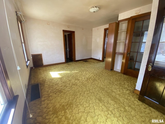 empty room with visible vents and baseboards