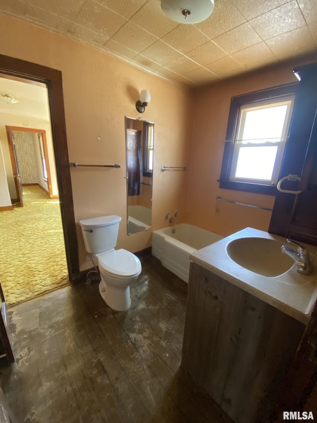 bathroom with toilet, baseboards, wood finished floors, and vanity