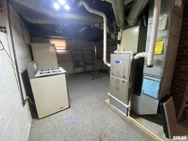 below grade area featuring heating unit, fridge, and washer / clothes dryer