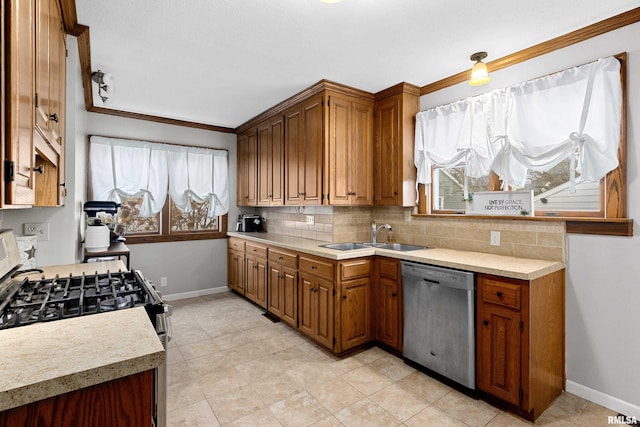 kitchen featuring a sink, stainless steel appliances, tasteful backsplash, and light countertops