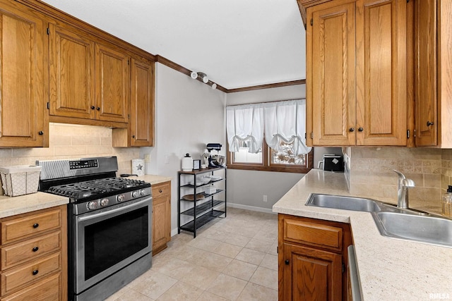 kitchen featuring brown cabinets, gas stove, light countertops, and crown molding