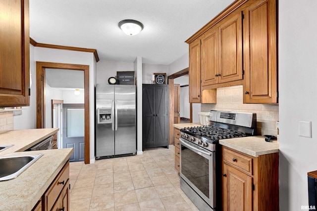 kitchen with stainless steel appliances, light countertops, and brown cabinets