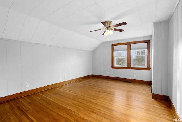 bonus room with vaulted ceiling, ceiling fan, light wood-style flooring, and visible vents