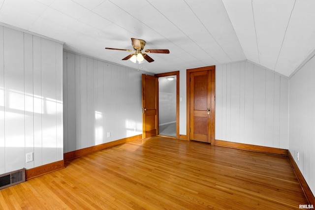 bonus room with a ceiling fan, visible vents, vaulted ceiling, and wood finished floors