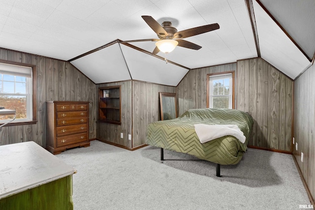 bedroom featuring lofted ceiling, multiple windows, a ceiling fan, and light carpet