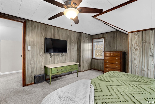 bedroom featuring light carpet, wooden walls, visible vents, and baseboards