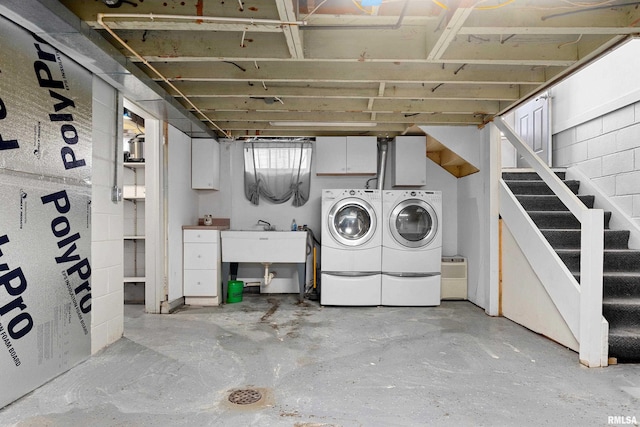 basement with independent washer and dryer, a sink, and stairs