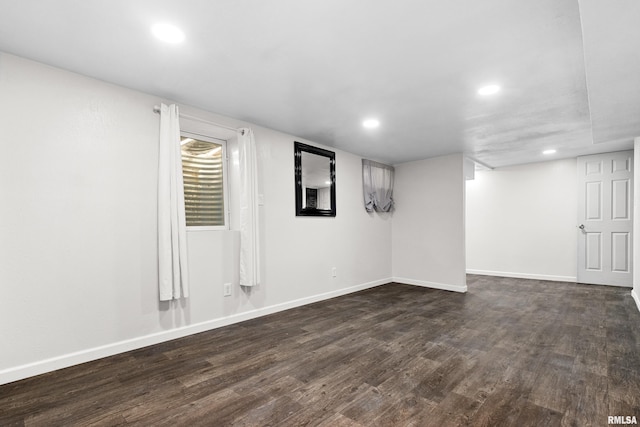 basement featuring dark wood-style flooring, recessed lighting, and baseboards