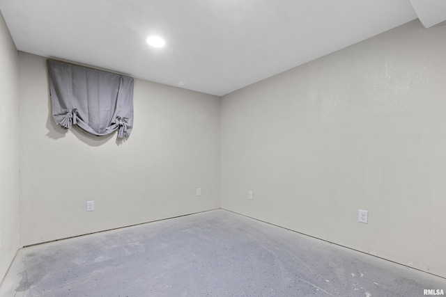 unfurnished room featuring concrete flooring