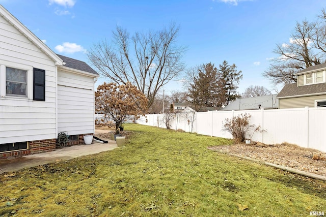 view of yard featuring a patio area and a fenced backyard