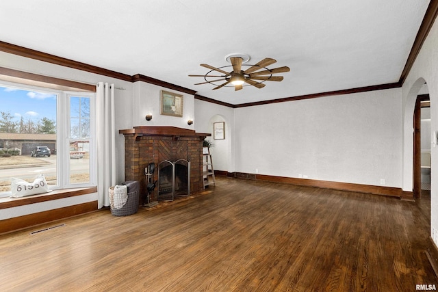 living area featuring arched walkways, a fireplace, wood finished floors, visible vents, and baseboards