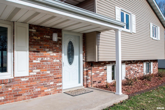 property entrance with brick siding