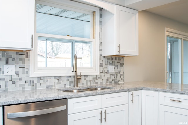 kitchen featuring a sink, light stone countertops, white cabinets, and dishwasher