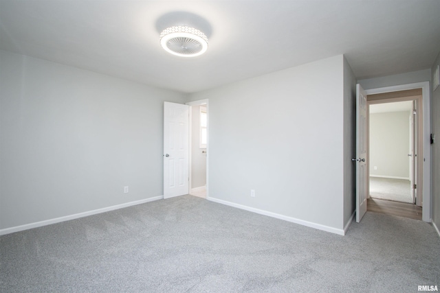 unfurnished bedroom with baseboards and carpet flooring