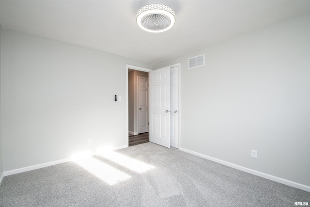 unfurnished room featuring light carpet, baseboards, and visible vents