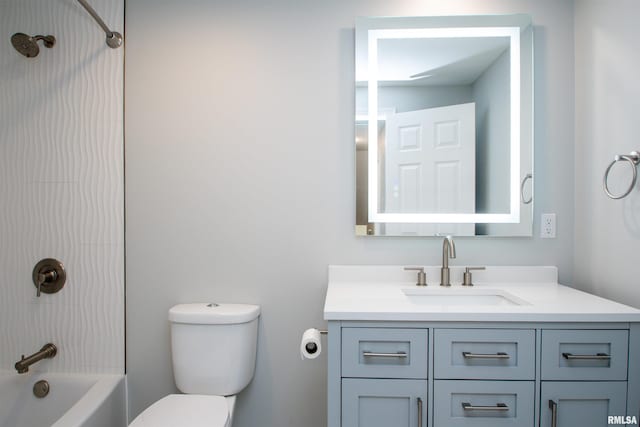 bathroom featuring bathtub / shower combination, vanity, and toilet