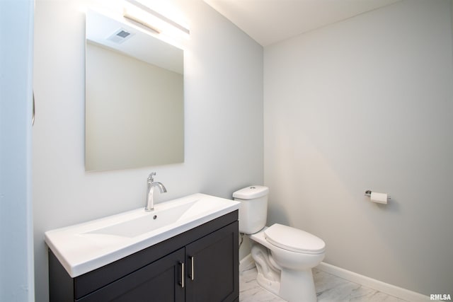 bathroom featuring visible vents, baseboards, toilet, marble finish floor, and vanity