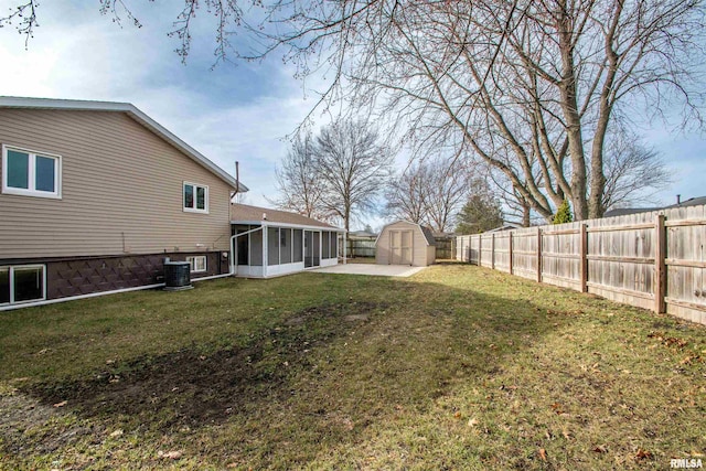 view of yard with a fenced backyard, cooling unit, a storage shed, an outdoor structure, and a sunroom