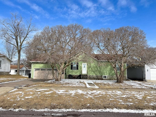 view of front facade with entry steps, driveway, and a garage