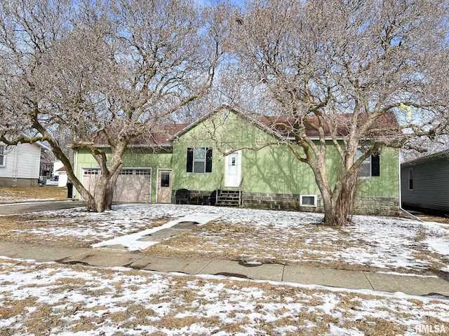 view of front facade featuring an attached garage and entry steps