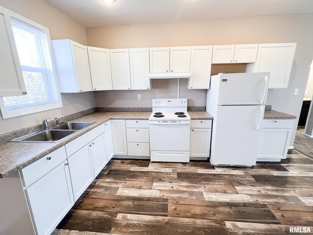 kitchen featuring white appliances, white cabinets, dark wood-type flooring, under cabinet range hood, and a sink