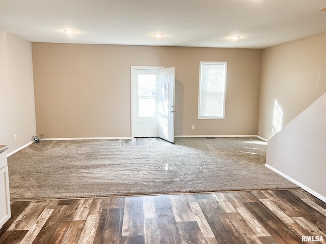 empty room featuring wood finished floors and baseboards