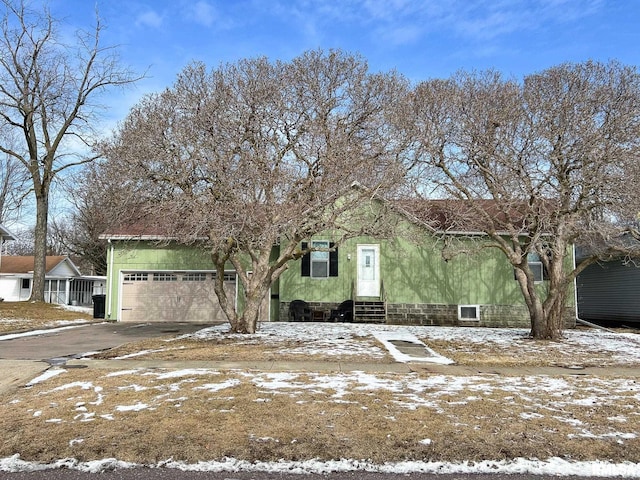 view of front of home with a garage, entry steps, and driveway