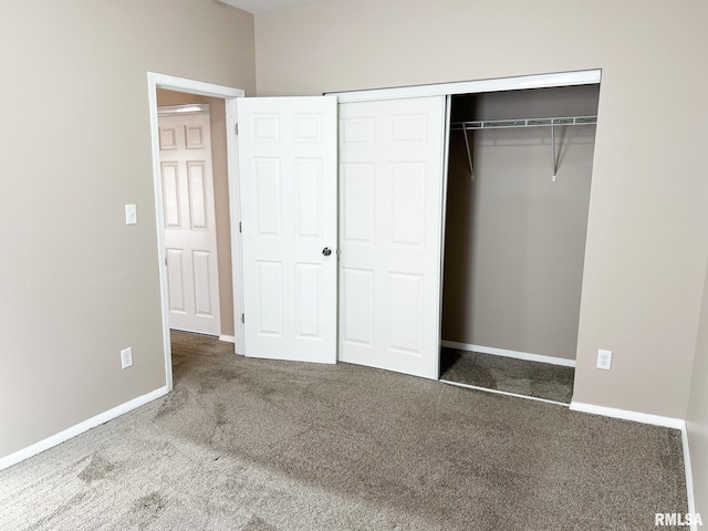 unfurnished bedroom featuring a closet, carpet, and baseboards