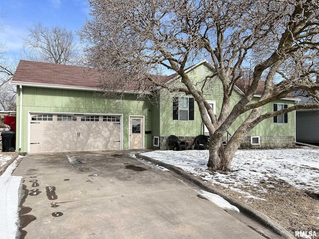 view of front of home with concrete driveway and an attached garage