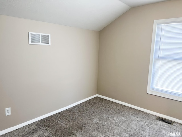 carpeted empty room with a healthy amount of sunlight, visible vents, and baseboards