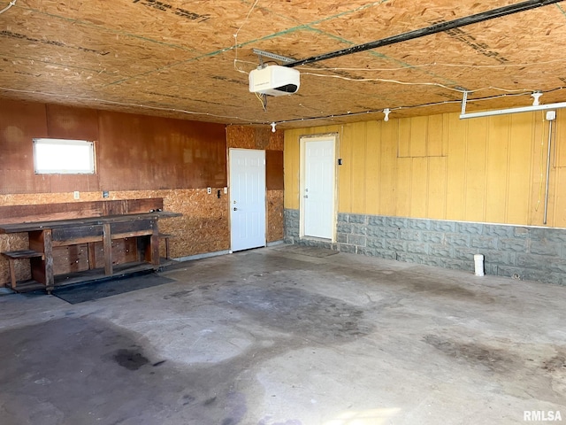 garage with a workshop area and a garage door opener