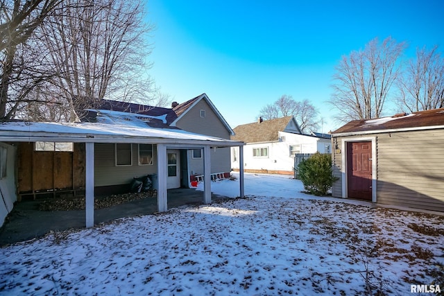 snow covered property with a chimney