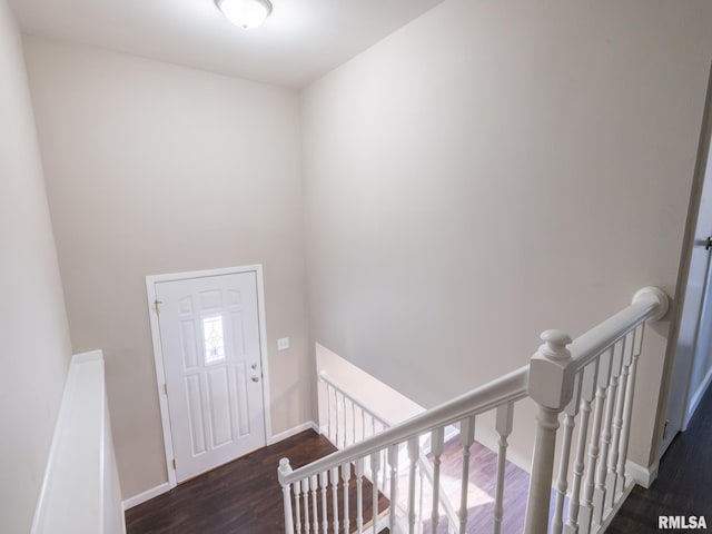 foyer featuring dark wood finished floors and baseboards