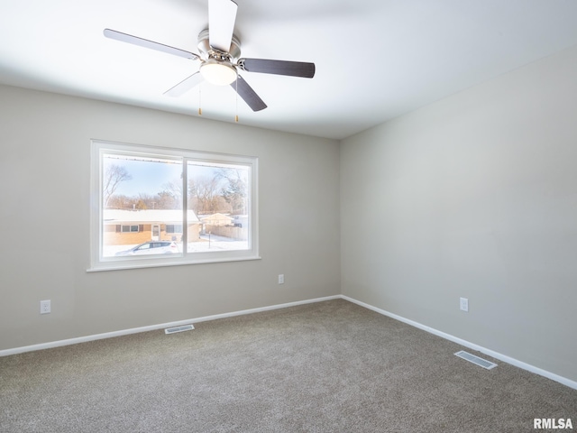 unfurnished room featuring carpet, visible vents, ceiling fan, and baseboards