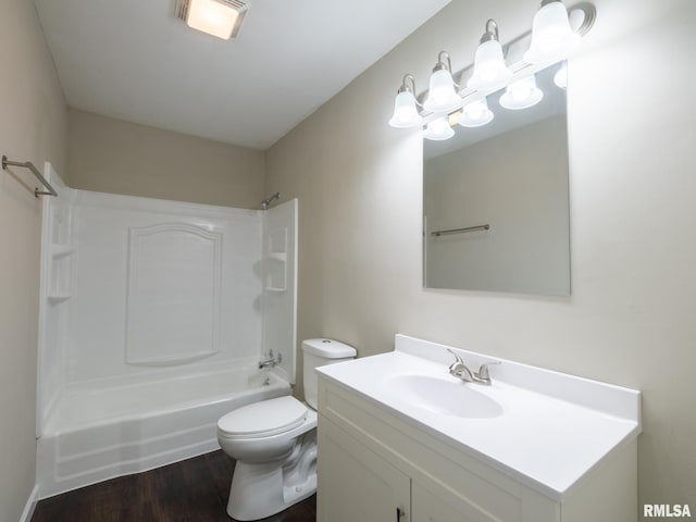 bathroom featuring toilet, tub / shower combination, wood finished floors, and vanity