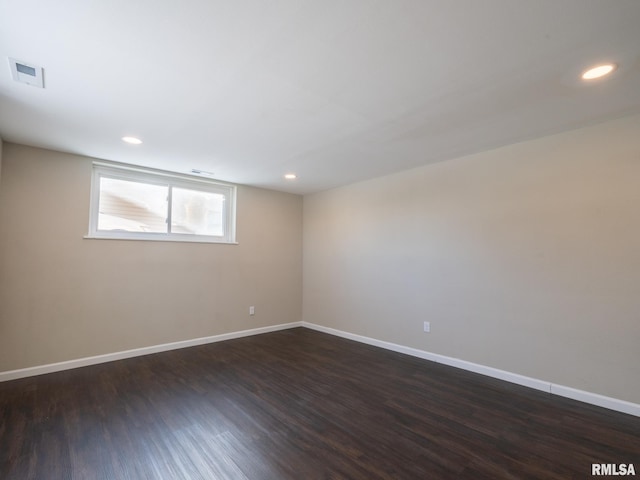 unfurnished room with recessed lighting, visible vents, dark wood finished floors, and baseboards