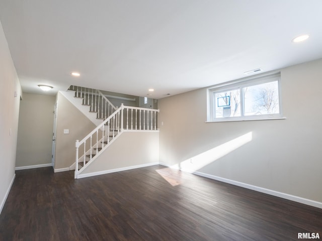 spare room featuring stairs, dark wood-style flooring, recessed lighting, and baseboards