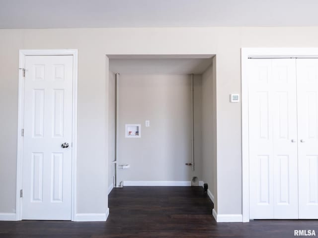 laundry room with laundry area, baseboards, and dark wood-type flooring